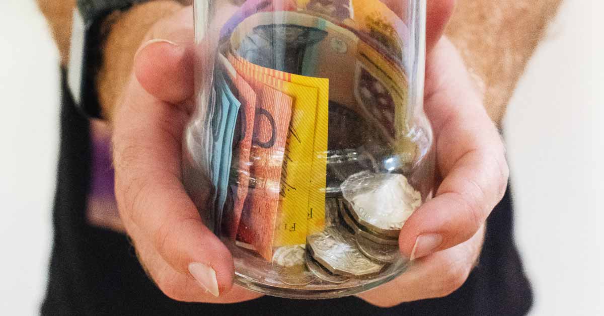 Money sitting in a glass mason jar